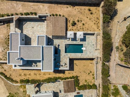 an aerial view of a house with a pool at Nevermind Vacations villa A in Kastrianí