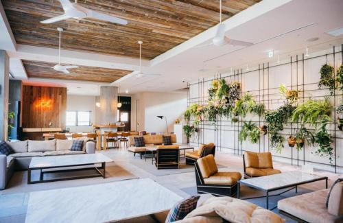 a living room with plants on the walls at Hotel It Osaka Shinmachi in Osaka