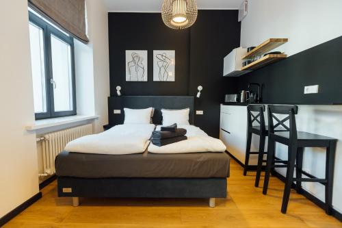 a bedroom with a bed and a black wall at NEW! Elegant Park Studio with A/C near Old Town in Riga