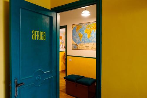 a blue door in a room with a map on the wall at Habari We Dorm in Bari