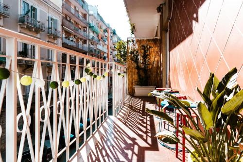 a balcony of a building with plants and a fence at Habari We Dorm in Bari