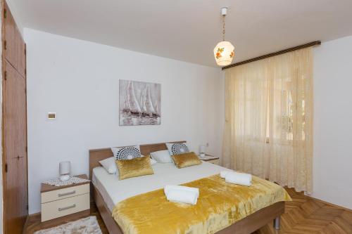 a white bedroom with a bed and a window at Sunset Bay Room in Dubrovnik