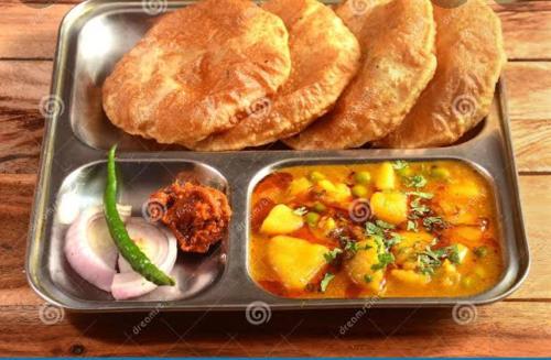 a lunch box with nepalese food and bread at SHRISTI HEIGHT in Kolkata