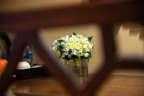 a vase of flowers sitting on a table at Hanoi Lakeside Premium Hotel & Travel in Hanoi