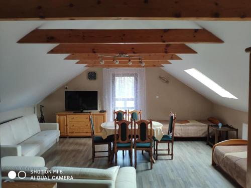 a living room with a table and chairs and a couch at Agroturystyka Patynówka in Kletno