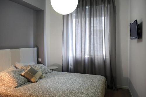 a bedroom with a bed and a large window at Dante 12 in Vigevano