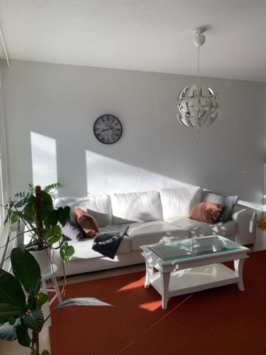 a living room with a white couch and a table at Holiday Home Turku City in Turku
