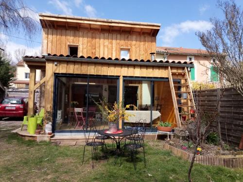 a small house with a table in the yard at Chalet cosy à Lamastre, jardin clos in Lamastre
