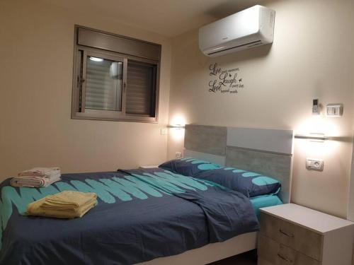 a bedroom with two beds and a window at Kiryat Tivon, Close by - Oranim College + parking in Oranim