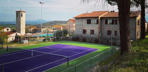 a tennis court with a tennis racquet on it at Albergo Di Murlo in Murlo