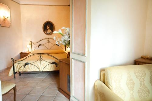 a bedroom with a bed and a table at Hotel Villa Torre Antica in Atena Lucana