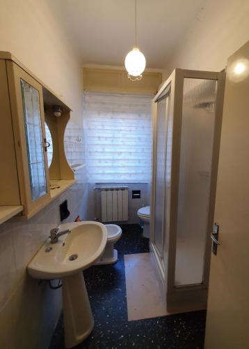 a bathroom with two toilets and a sink and a shower at CasaMarea in Grottammare