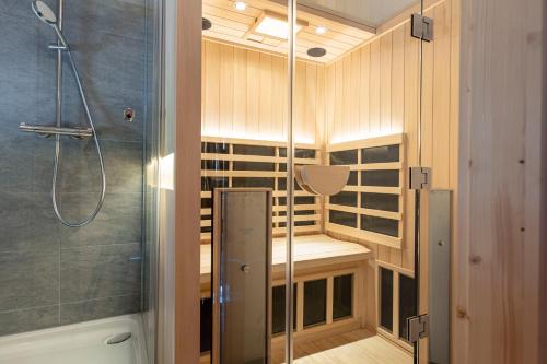 a bathroom with a shower and a shower stall at Kreischberg Chalets by ALPS RESORTS in Sankt Lorenzen ob Murau