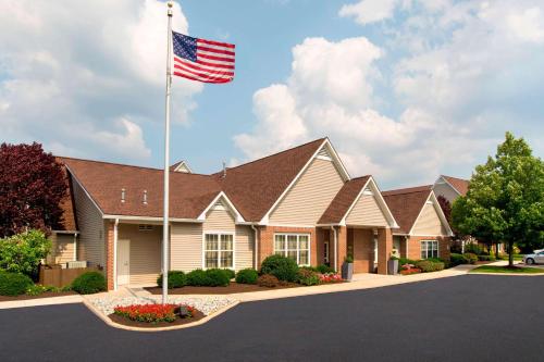 a house with an american flag in front of it at Sonesta ES Suites Allentown Bethlehem Airport in Bethlehem