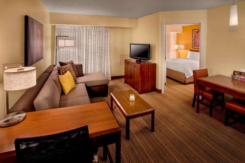 a hotel room with a couch and a bed at Sonesta ES Suites Allentown Bethlehem Airport in Allentown