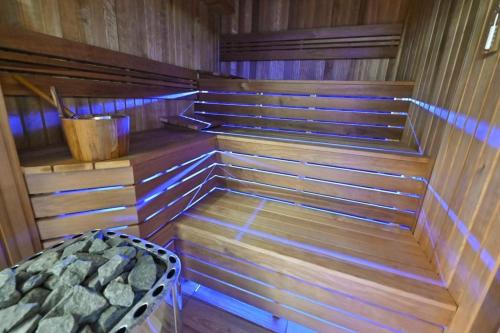 a sauna with wooden steps and a bed in it at Hotel Rudnik in Grudziądz