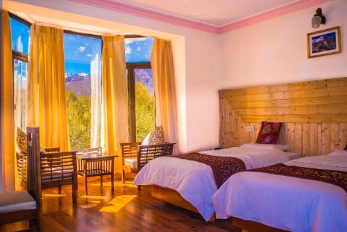 a hotel room with two beds and a window at The Nature Residency - A Riverside Resort in Leh in Leh