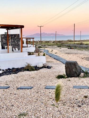a beach with rocks and a pavilion in the desert at Aeron Suites in Éxo Goniá