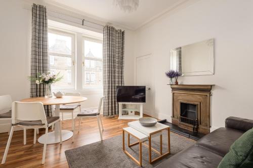 a living room with a couch and a table at The London Road Apartment - 2BR/1BA in Edinburgh