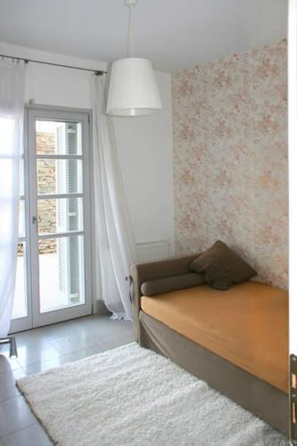 a bedroom with a bed and a large window at Villa Litharia, enchanting location and view in Ioulida