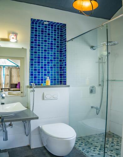 a bathroom with a toilet and a sink and a shower at Hydrangea Villa in Kodaikānāl