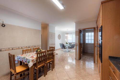 a kitchen and dining room with a table and chairs at Sunnyside Villa in Arco da Calheta