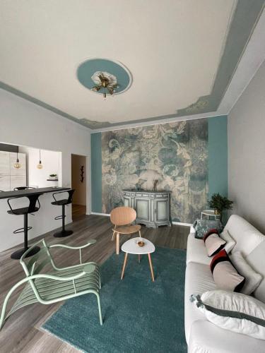 a living room with a couch and a table at Aurora Flowers - Two rooms and free parking near center and train station in Modena