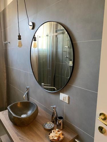 a bathroom with a black sink and a mirror at Aurora Flowers - Two rooms and free parking near center and train station in Modena