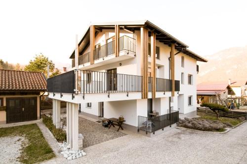 an image of a house with a balcony at Apartments ALPA VITA in Kobarid