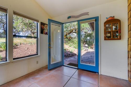 an empty room with a blue door and windows at Healdsburg Home with Magnificent Vineyard View home in Healdsburg