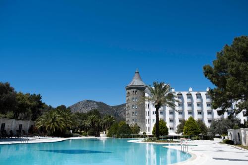 a large swimming pool in front of a building at X Life Hotel Sarıgerme 15 - Adult Hotel in Sarigerme
