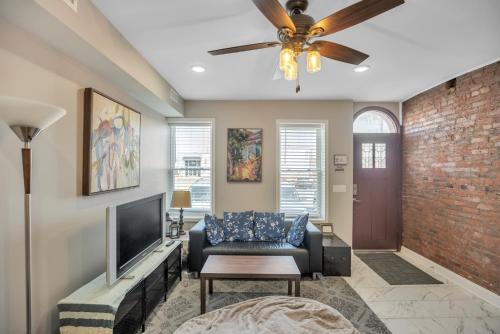 a living room with a couch and a television at Enjoy Your Stay in this Amazing Location in Philadelphia! home in Philadelphia