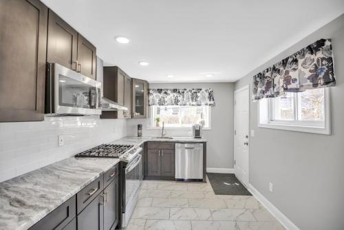 a kitchen with white counters and a stove top oven at Enjoy Your Stay in this Amazing Location in Philadelphia! home in Philadelphia