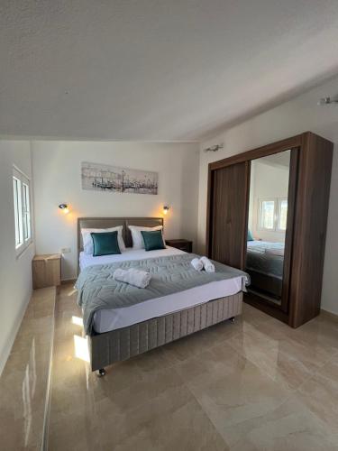 a bedroom with a large bed and a large mirror at Venice Apartments in Tivat