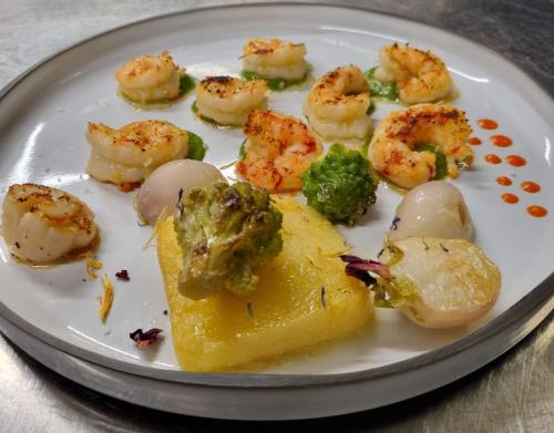 a plate of food with shrimp and vegetables on it at Logis Hotel Schaeffer- Restaurant Le Saint Georges in Serrières
