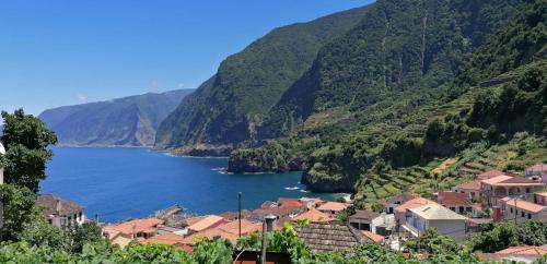 a town on a hill with a body of water at Chalé Seixal - Sea View in Seixal