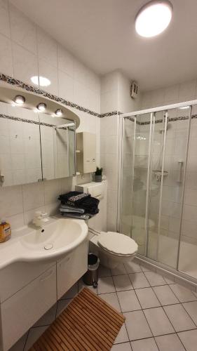 a bathroom with a shower and a sink and a toilet at NordseeGlück in Cuxhaven