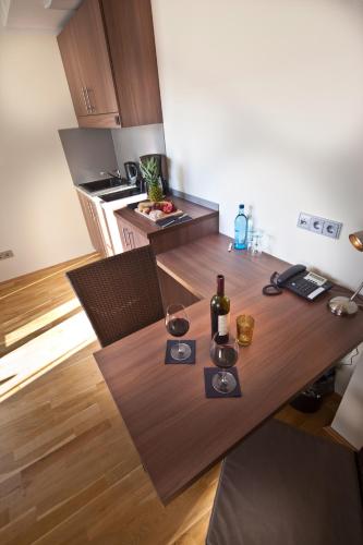 a kitchen with a wooden table with wine glasses on it at GuestHouse Mannheim in Mannheim