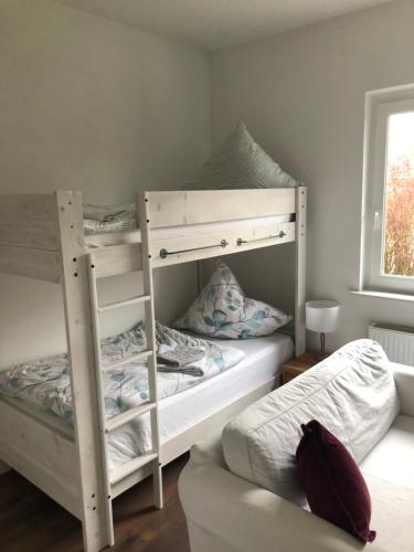 a bedroom with two bunk beds and a window at Haus Pazarcik in Nordenham