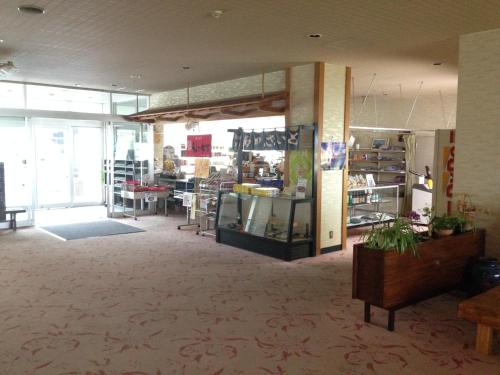 a large room with a store with tables and windows at Hokkai Hotel in Lake Toya