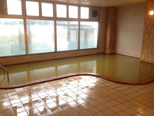 a room with a pool of water on the floor at Hokkai Hotel in Lake Toya