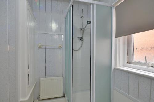 a shower with a glass door in a bathroom at Rooms at 153 ROOM ONLY in Scarborough