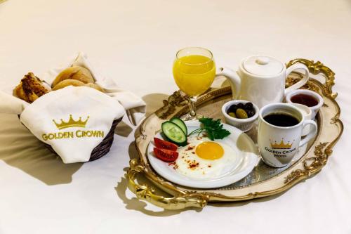 a breakfast tray with an egg and coffee and toast at Golden Crown Hotel in Istanbul