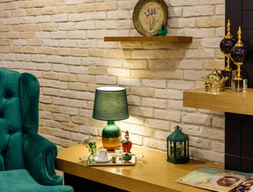 a green lamp on a desk next to a chair at Golden Crown Hotel in Istanbul