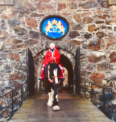 a man riding a horse through a tunnel at Soldatens Bed & Breakfast in Marstrand