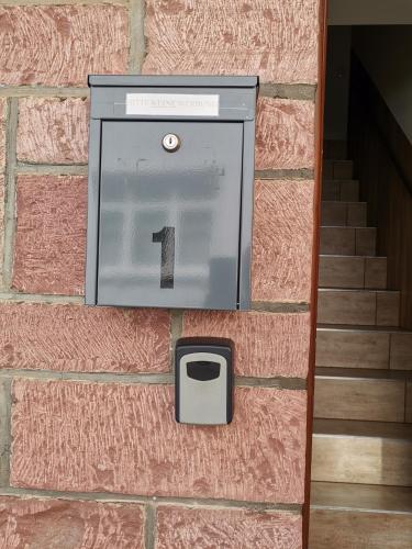 a box on the side of a brick wall at Ferienwohnung mit Aussicht auf die Burg in Wertheim