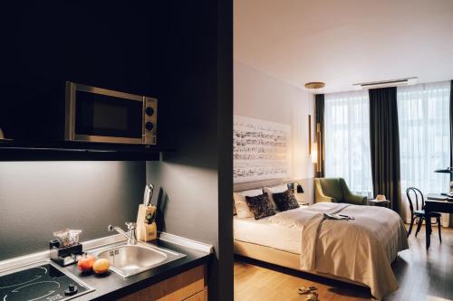 a bedroom with a bed and a sink in a room at Townhouse Leipzig in Leipzig