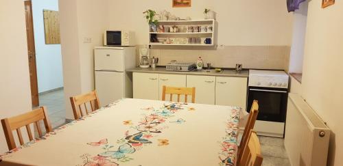 a kitchen with a table with a table cloth on it at Pataki House in Mórahalom