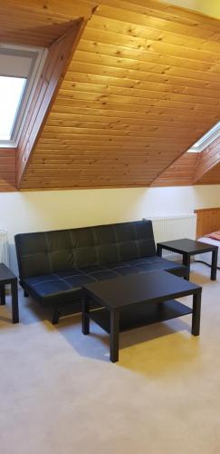 a living room with a couch and two tables at Pataki House in Mórahalom