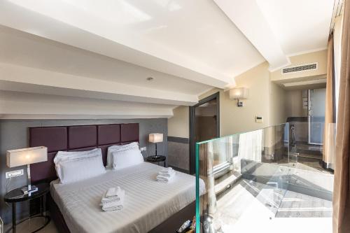 Un ou plusieurs lits dans un hébergement de l'établissement Hotel Castellino Roma